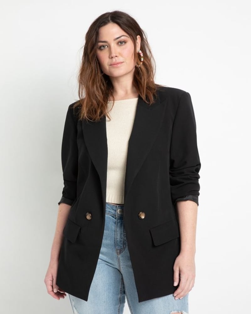 Front of a model wearing a size 24 Long Relaxed Blazer in Totally Black by ELOQUII. | dia_product_style_image_id:309966